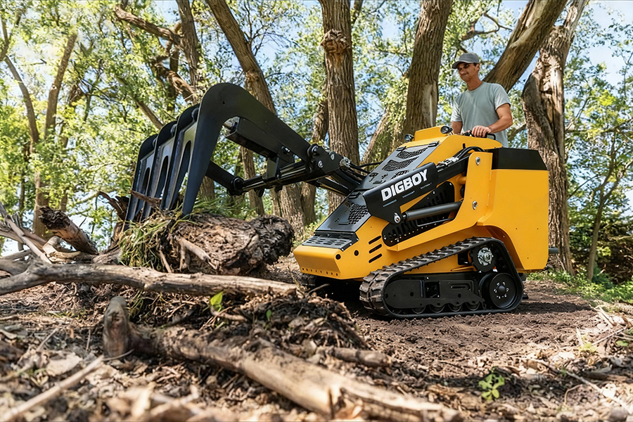 A DIG-BOY mini skid steer used as landscaping construction equipment to move mulch